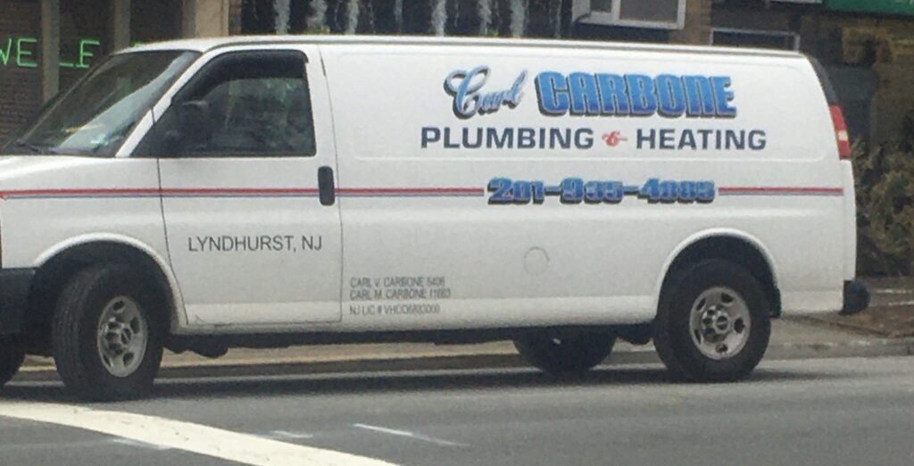 Carl Carbone Plumbing & Heating service van lettered with the company name, phone number and Lyndhurst, NJ